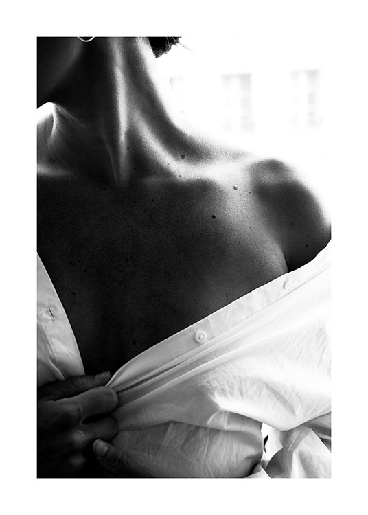  – Svarthvitt-fotografi av en naken skulder på en kvinne iført en hvit skjorte