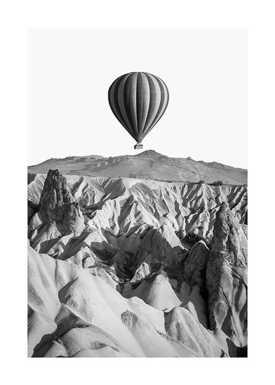  - Svart-hvitt fotografi av et steinete fjellandskap og en luftballong