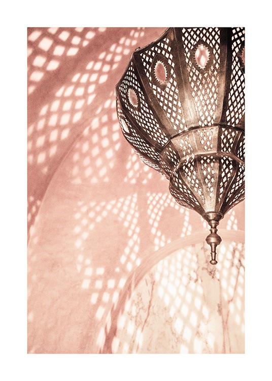  - Fotografi av et rosa rom med en metallampe som reflekterer et mønster på veggene