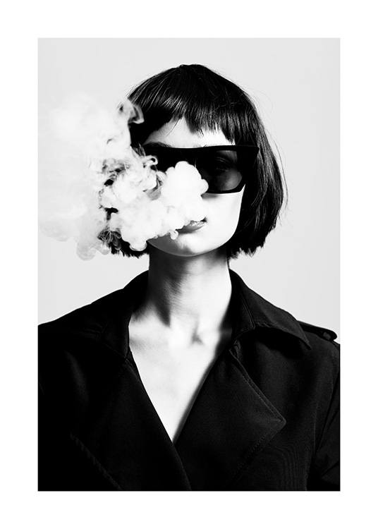  – Svarthvitt-fotografi av en kvinne iført solbriller og jakke, som slipper røyk ut fra munnen