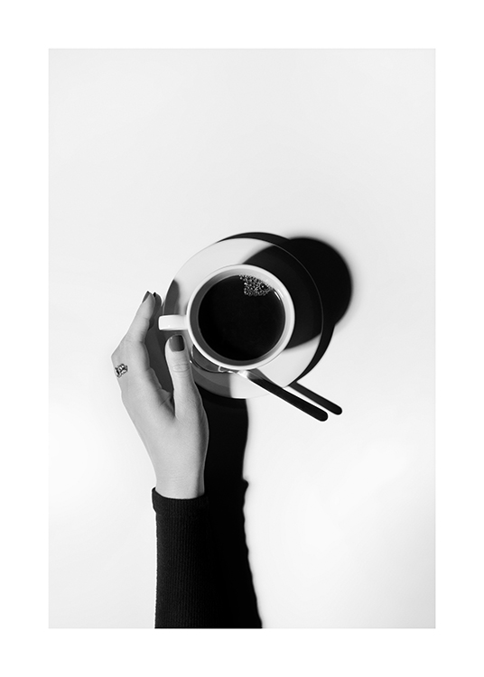 – Svarthvitt-fotografi med en kaffekopp i midten og en hånd som strekker seg mot den