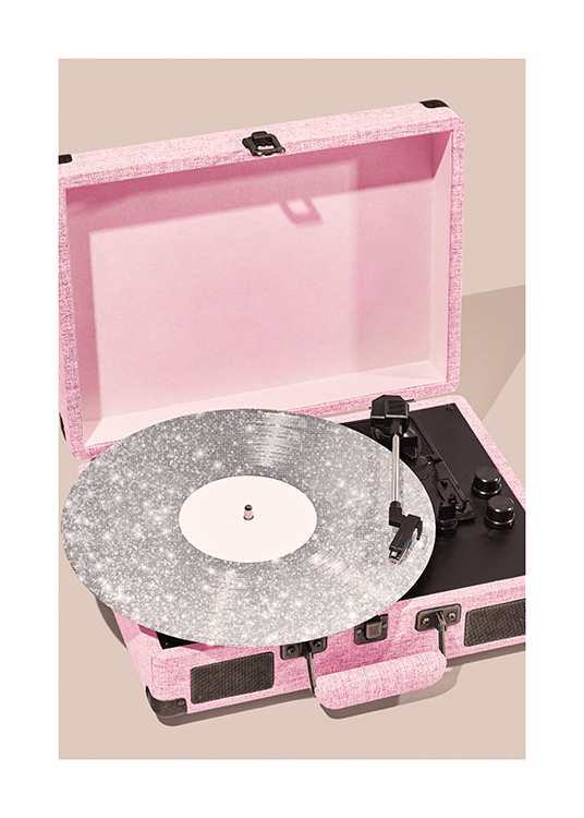 – Fotografi av en rosa platespiller med en sølvfarget, glitrende plate